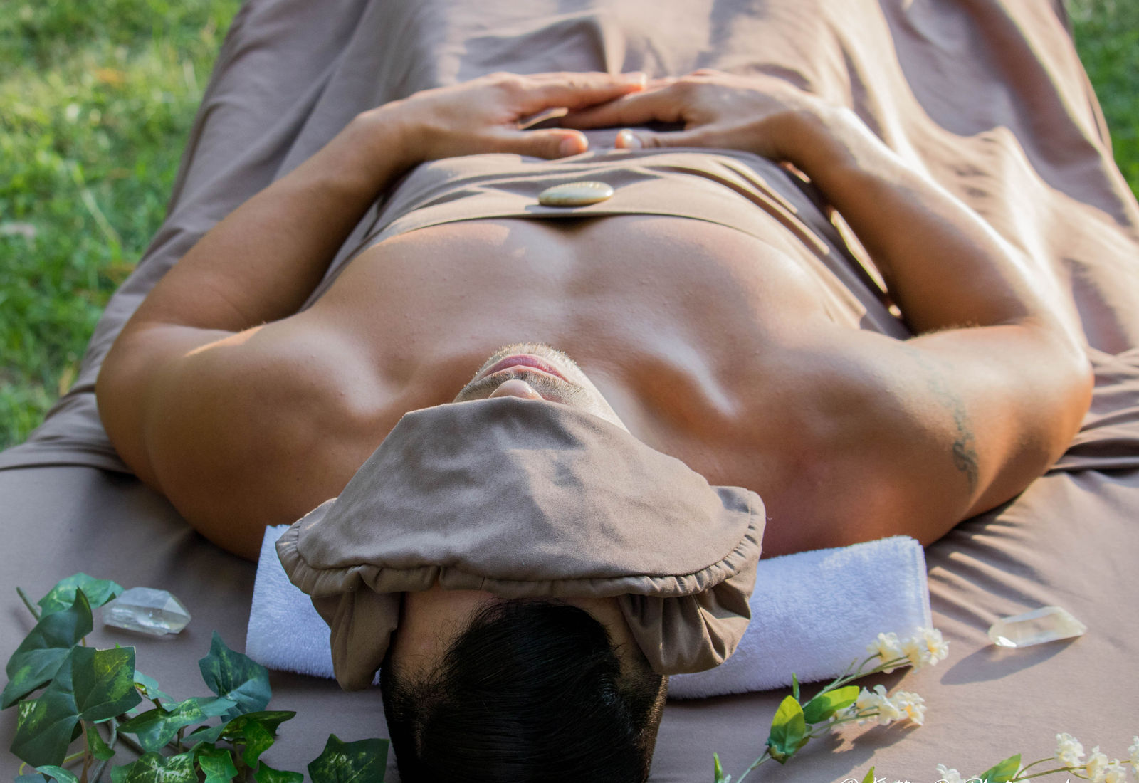 A client relaxing during an outdoor therapeutic massage